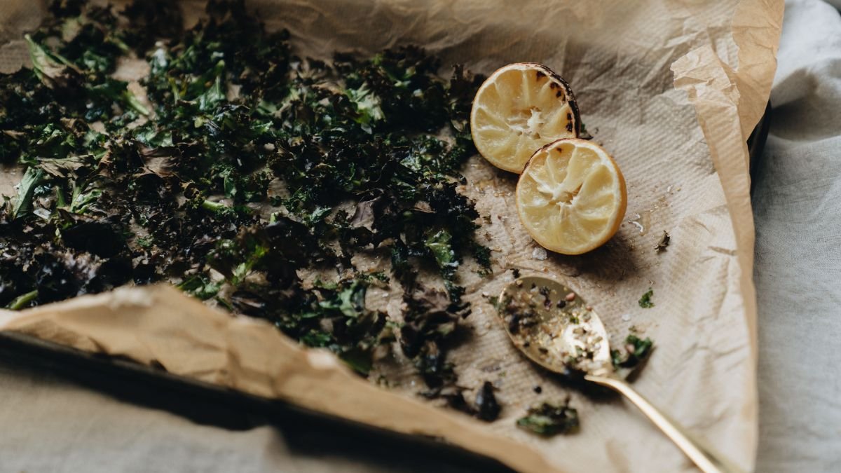 Herb leaves in a single layer on a baking sheet for oven drying